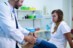 Doctor assessing a patient with a minor injury at an urgent care clinic.