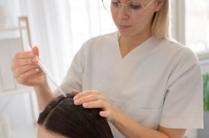 The Most Common Reasons People Experience Changes in Hair Growth Woman examining changes in hair thickness and growth in a mirror.
