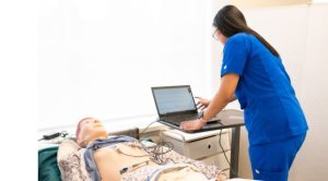 How to Advance In Your Nursing Career Without Hitting Pause Experienced nurse with a patient in medical setup