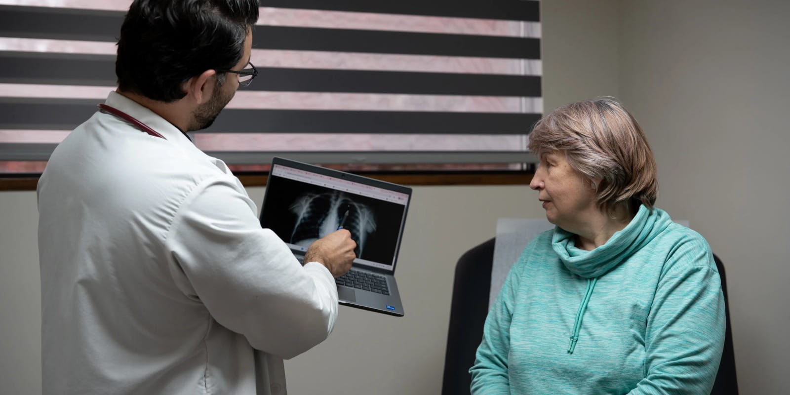 doctor showing radiological scans to patient