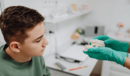 Person after receiving restorative dental treatment for tooth loss.