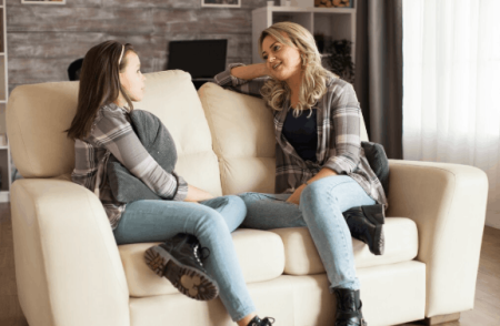 What’s the Best Way to Start a Conversation With Your Teen and Keep It Flowing? Parent having a relaxed conversation with a teenager at home.