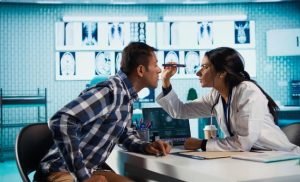 Eye doctor examining a patient's eyes during a comprehensive eye exam
