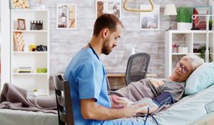 How Hospice Care Helps Improve Quality of Life for Patients With Serious Illnesses Hospice care professional offering comfort and emotional support to a patient and family member